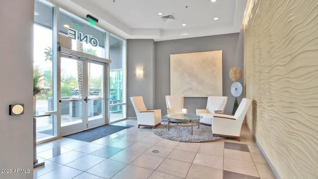 a living room with a large window and furniture