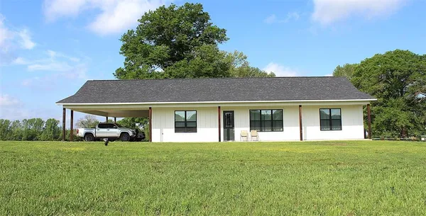 a front view of house with yard and green space