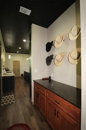 a kitchen with a refrigerator and a stove top oven