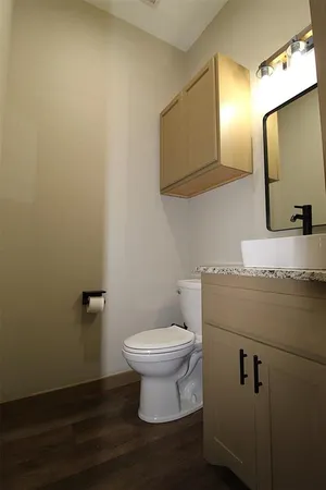 a bathroom with a sink toilet and mirror