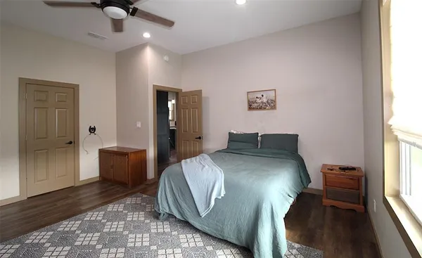 a spacious bedroom with a bed and a window