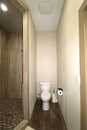 a bathroom with a toilet and a shower