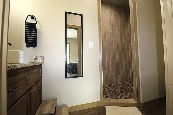 a bathroom with a shower and a sink