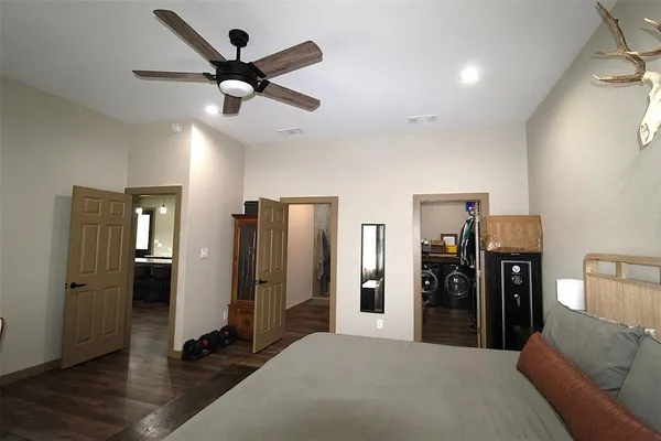 a living room with stainless steel appliances kitchen island furniture and a ceiling fan