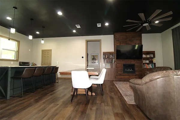 a living room with furniture a flat screen tv and a fireplace