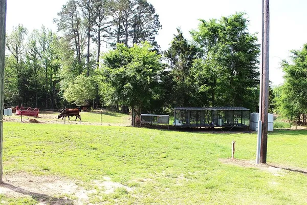 a swimming pool with trees in the background