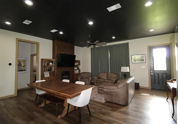 a living room with furniture a flat screen tv and a table