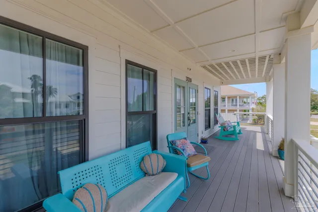 a living room with furniture kitchen view and a flat screen tv