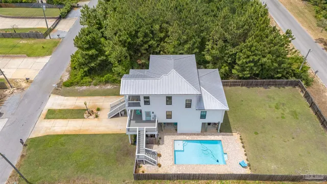 an aerial view of a house with a yard basket ball court and outdoor seating