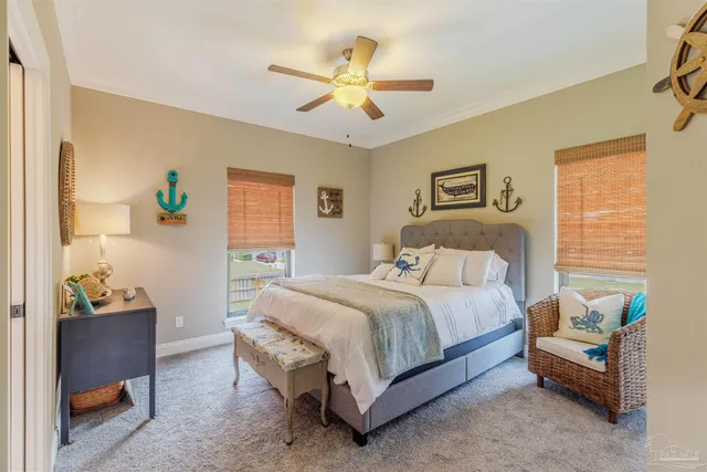 a bedroom with furniture and large windows