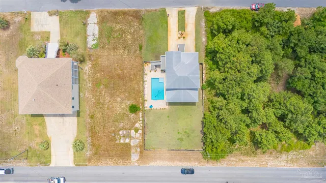 an aerial view of a house with a yard