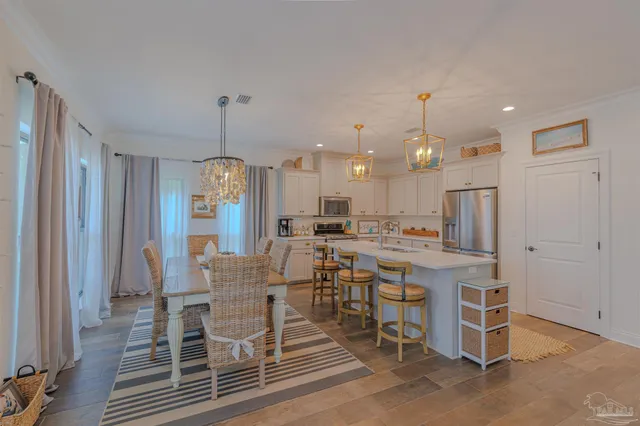 a large kitchen with a table and chairs