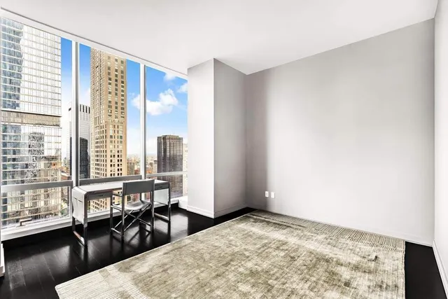 a living room with furniture and large windows