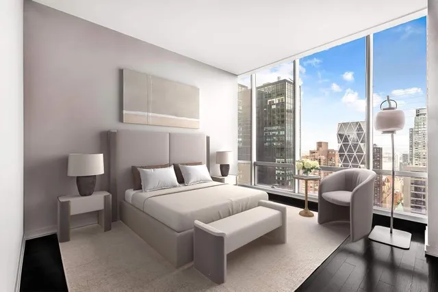 a bedroom with furniture and a large window