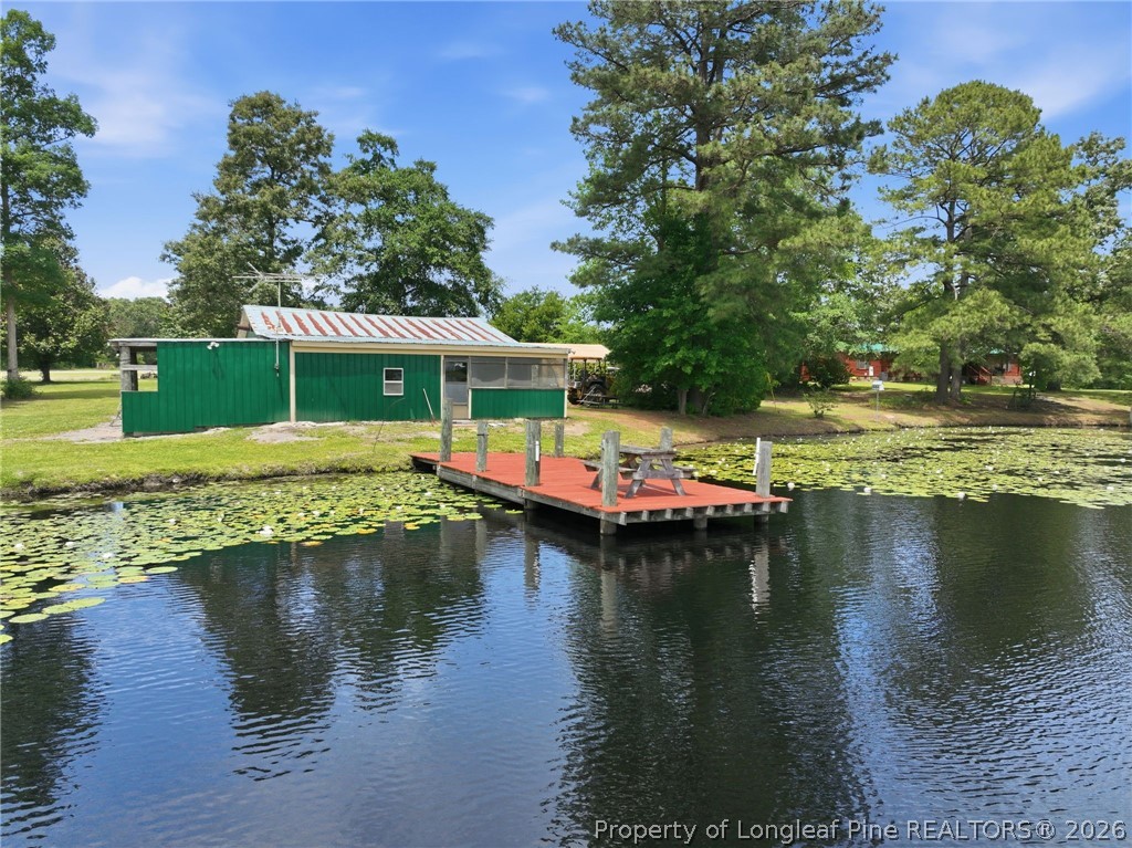 10400 Ruth Vinson Road Autryville, NC 28318 - Photo 6 of 49 a view of a lake with houses