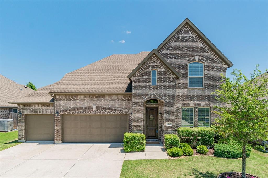 4210 Magnolia Road Melissa, TX 75454 - Photo 1 of 22 Brick exterior with an arched entryway, two-car garage, and established landscaping