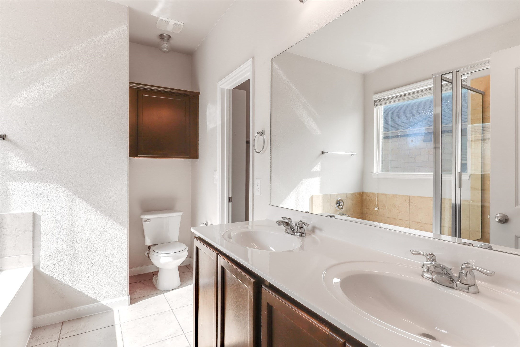 18705 Moreto Loop Pflugerville, TX 78660 - Photo 11 of 21 Double vanity and a deep soaking tub create a luxurious private retreat.