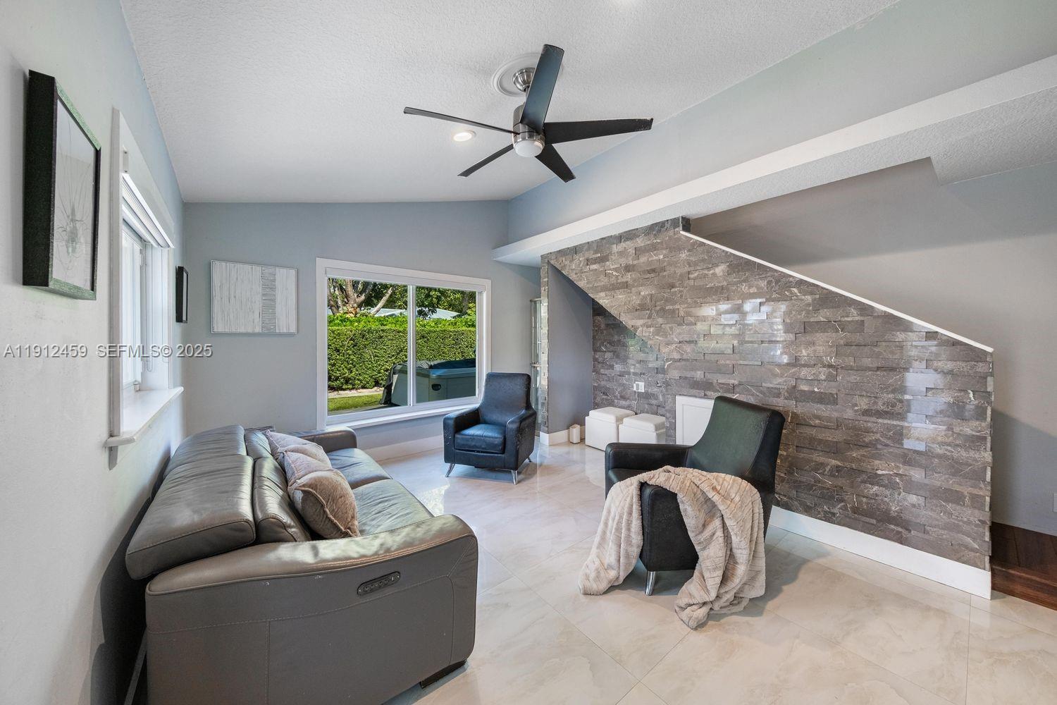 10025 Southwest 83rd Street Miami, FL 33173 - Photo 11 of 37 a living room with furniture and a large window