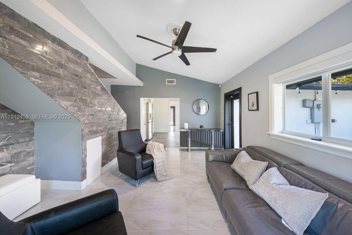 10025 Southwest 83rd Street Miami, FL 33173 - Photo 12 of 37 a living room with furniture and a large window