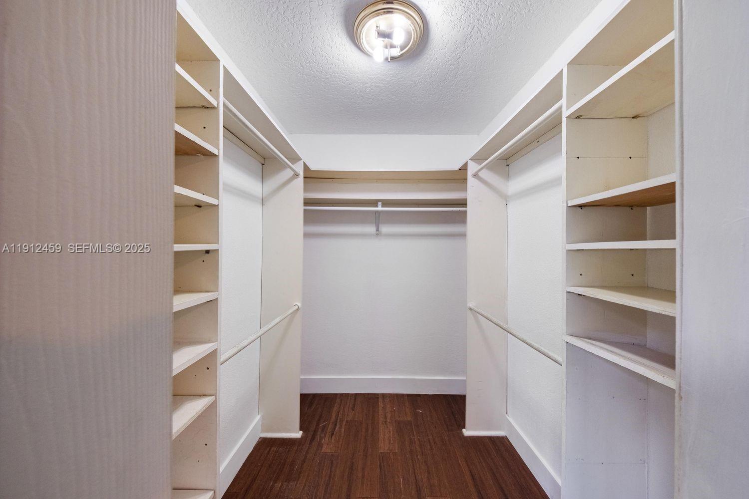 10025 Southwest 83rd Street Miami, FL 33173 - Photo 17 of 37 a view of walk in closet with empty racks