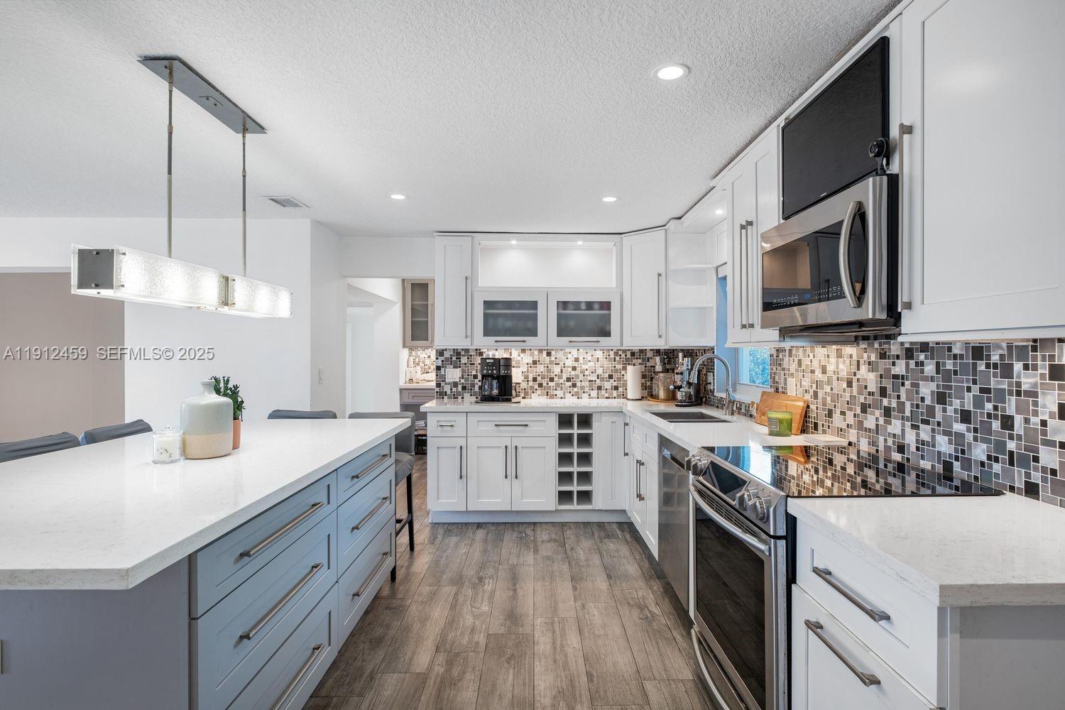 10025 Southwest 83rd Street Miami, FL 33173 - Photo 3 of 37 a kitchen with sink cabinets and stainless steel appliances