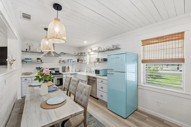 a kitchen with stainless steel appliances granite countertop furniture and a refrigerator