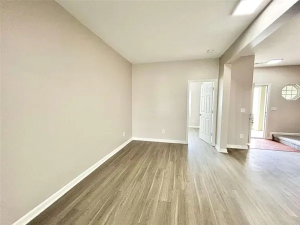 a view of an empty room and wooden floor