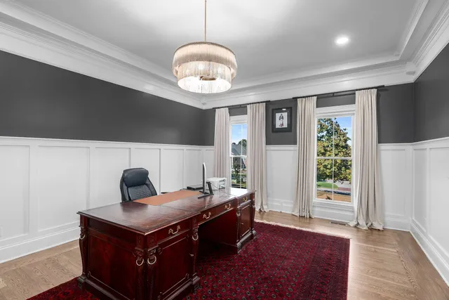 a kitchen with kitchen island granite countertop lots of white cabinets stainless steel appliances and a center island