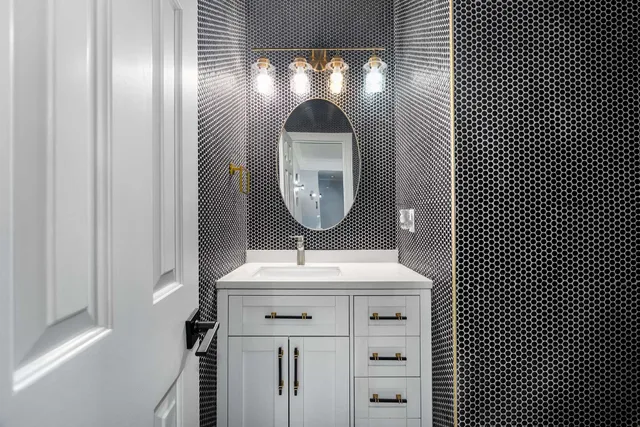 a large white kitchen with a large counter top appliances and cabinets