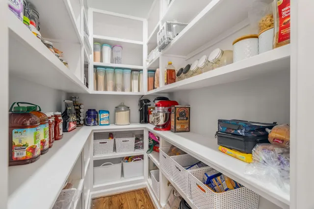 a living room with furniture large window and flat screen tv