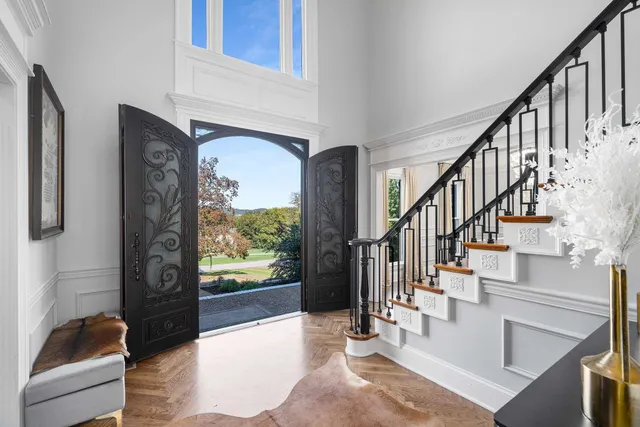 a view of entryway and hall with wooden floor
