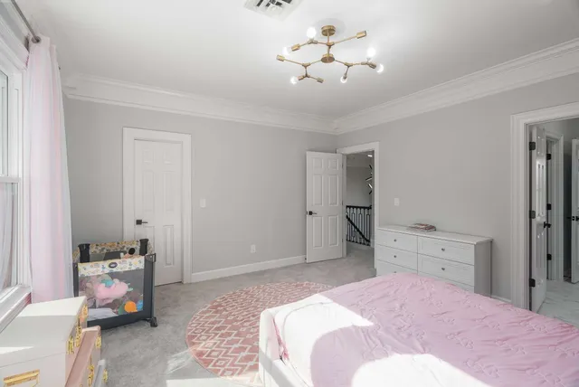 a view of a livingroom with a piano and a chandelier