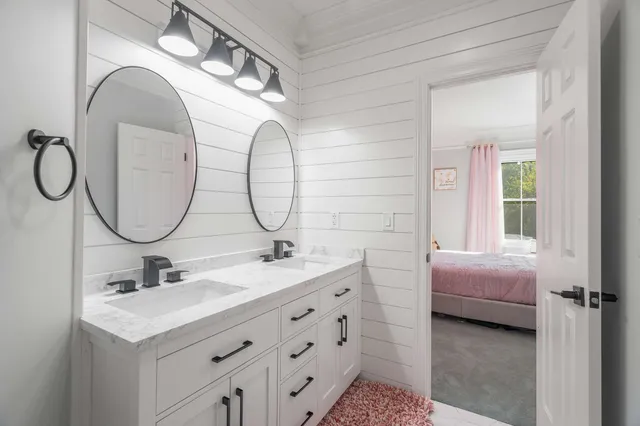 a bathroom with 2 sink and a mirror