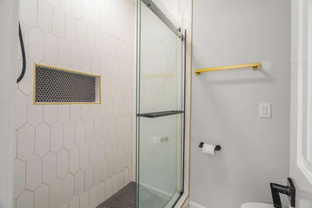 a bathroom with a white tub a shower and a sink