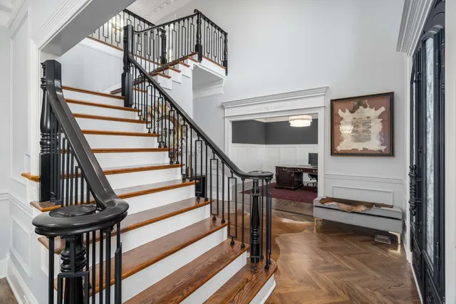 a living room with furniture a chandelier and a window