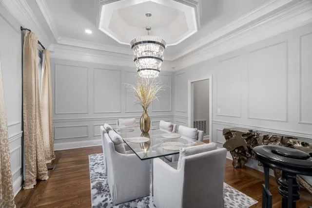a view of a dining room with furniture wooden floor and chandelier