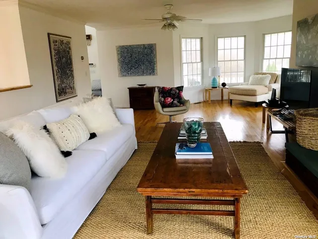 a living room with furniture a rug and a flat screen tv