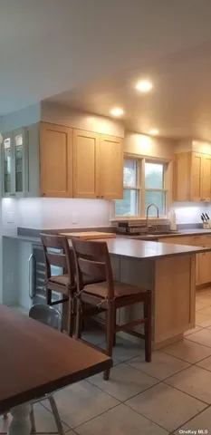a kitchen with a table chairs and a sink