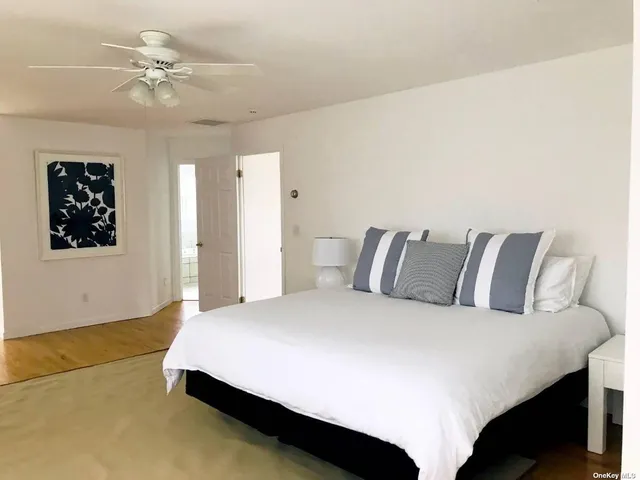 a large bed sitting in a bedroom and a chandelier