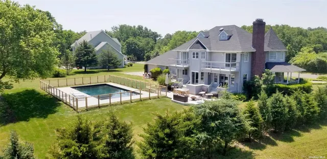 an aerial view of a house with swimming pool garden and patio