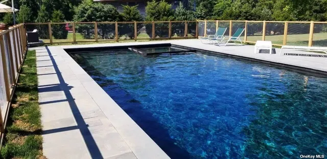 a view of a house with a wooden deck