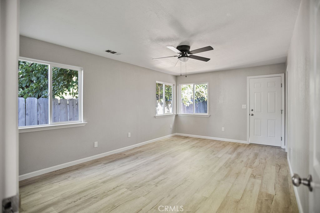 2525 R Street Merced, CA 95340 - Photo 11 of 19 a view of an empty room with a window and wooden floor