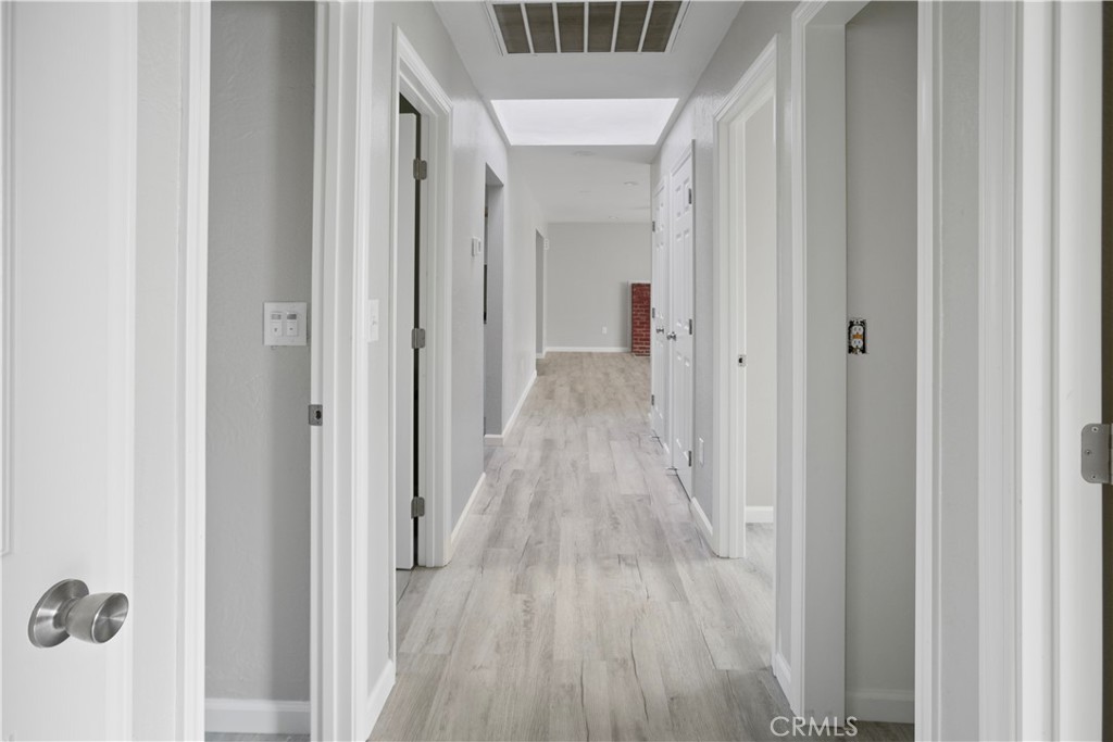 2525 R Street Merced, CA 95340 - Photo 14 of 19 a view of a hallway with wooden floor and staircase