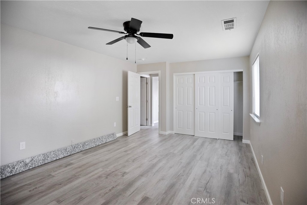 2525 R Street Merced, CA 95340 - Photo 15 of 19 a view of room with hardwood floor ceiling fan