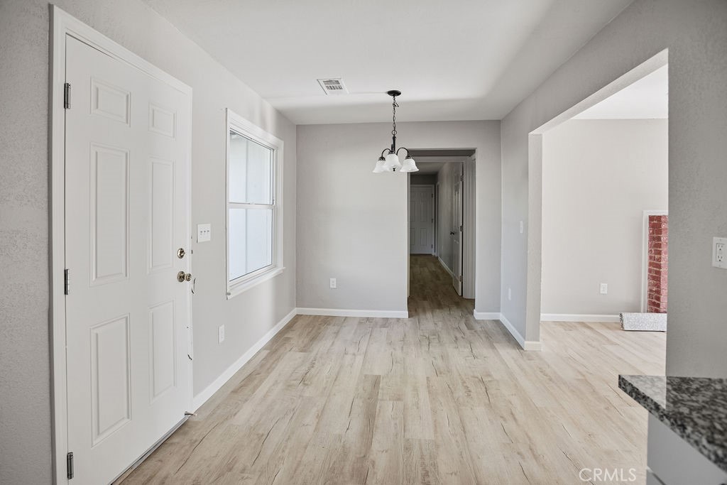 2525 R Street Merced, CA 95340 - Photo 2 of 19 a view of a room with wooden floor