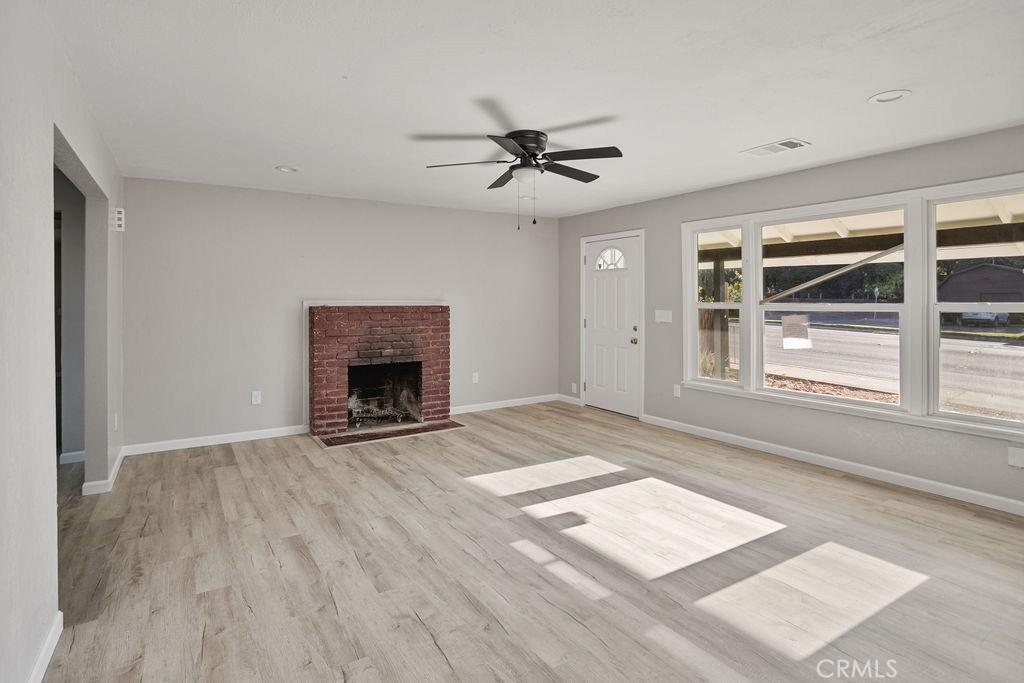 2525 R Street Merced, CA 95340 - Photo 3 of 19 an empty room with windows and fireplace