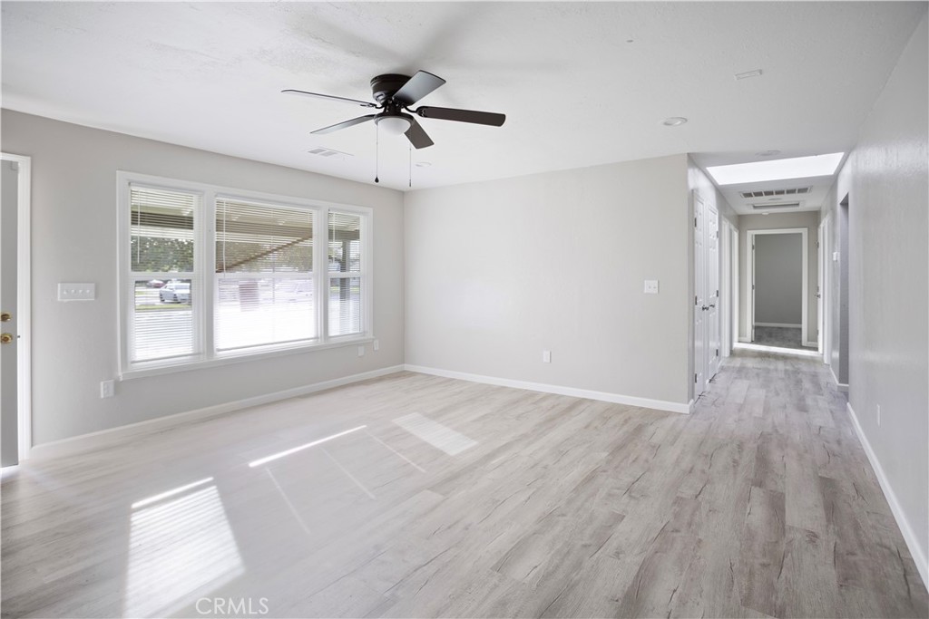 2525 R Street Merced, CA 95340 - Photo 4 of 19 a view of empty room with wooden floor and fan