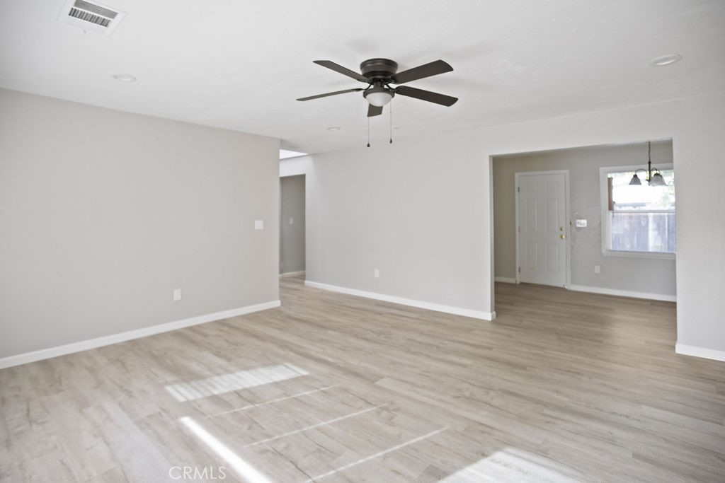 2525 R Street Merced, CA 95340 - Photo 5 of 19 a view of a livingroom with a ceiling fan & hardwood floor