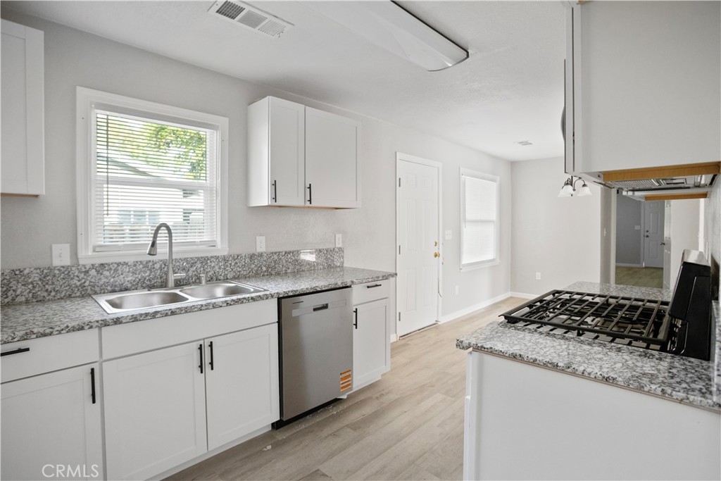 2525 R Street Merced, CA 95340 - Photo 7 of 19 a kitchen with a sink stove and cabinets