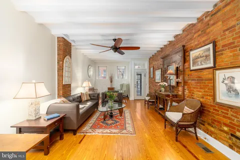 a living room with fireplace furniture and a rug
